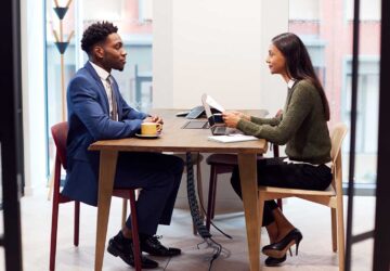 Businesswoman Interviewing Male Job Candidate In Meeting Room